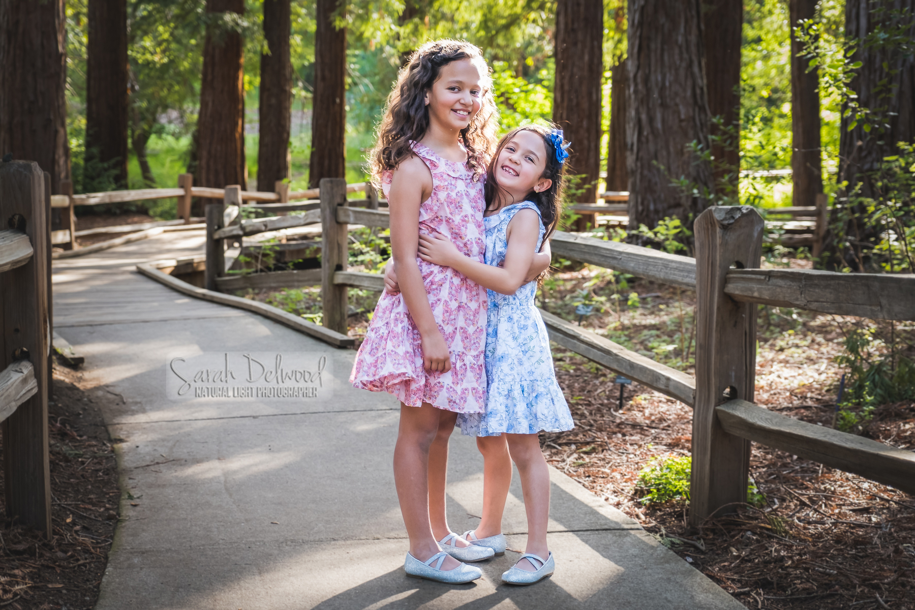 sisters hugging in Los Altos park during family portraits